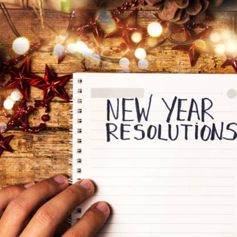 Person writing new year resolutions first person view
